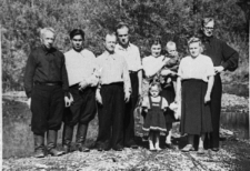 Grupa ludzi w letnich strojach. Od lewej: Landowski (Polak, majster), NN (Rosjanin), NN, Łotyszonek (utopił się w Kołymie), jego żona z dziećmi, NN, Henryk Meszczyński.
