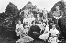 Grupa Polak&oacute;w na tle "kiziuku" (opału z nawozu).